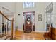 Elegant front door with decorative glass and sidelights, creating a grand entrance at 7455 Richmond Way, Cumming, GA 30040