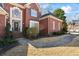 Charming front entrance with brick facade, decorative door, and curved walkway at 7455 Richmond Way, Cumming, GA 30040