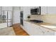 Kitchen featuring stainless steel appliances, white cabinetry, and granite countertops at 7455 Richmond Way, Cumming, GA 30040