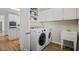 Bright laundry room features a sink, washer and dryer, and ample cabinet space near the kitchen at 7455 Richmond Way, Cumming, GA 30040