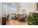 Cozy living room with large windows, hardwood flooring, and ample natural light at 7455 Richmond Way, Cumming, GA 30040