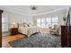 Spacious main bedroom with tray ceiling features a large rug and plenty of natural light at 7455 Richmond Way, Cumming, GA 30040
