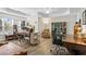 Sun-filled office with two large desks, bookshelves and windows showcasing natural light and a modern ceiling fan at 7455 Richmond Way, Cumming, GA 30040