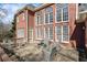 Brick home with a stone patio, plenty of seating, and large windows for natural light at 7455 Richmond Way, Cumming, GA 30040