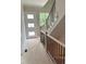 Entryway featuring a modern front door, stairs with wood handrail, and metal spindles at 001 White St # 1, Marietta, GA 30060