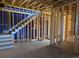 Framed staircase with open wall studs and exposed ceiling joists, pre-construction at 001 White St # 1, Marietta, GA 30060