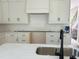 Spacious kitchen with white cabinets, black hardware, subway tile backsplash, and stainless sink at 001 White St # 1, Marietta, GA 30060