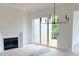 Bright living room with fireplace, sliding doors to the deck, and a modern chandelier at 001 White St # 1, Marietta, GA 30060
