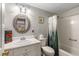 Well-lit bathroom featuring a vanity, toilet, and shower with decorative nature-themed shower curtain at 1501 Clairmont Rd # 535, Decatur, GA 30033