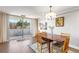 Bright dining area features wood floors, a modern chandelier, and a sliding door to balcony at 1501 Clairmont Rd # 535, Decatur, GA 30033