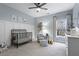 Stylish Bedroom featuring a black crib, board and batten accent wall, and ample natural light at 2061 Westwood Cir, Smyrna, GA 30080