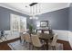 Beautiful dining room with a stylish chandelier, wainscoting, and ample natural light at 2061 Westwood Cir, Smyrna, GA 30080