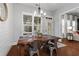 Cozy dining area featuring a rustic table set, plantation shutters, and a view into the living room at 2061 Westwood Cir, Smyrna, GA 30080