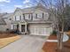 Beautiful two-story home featuring a welcoming front porch and a two-car garage with decorative accents at 2061 Westwood Cir, Smyrna, GA 30080