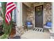 Close-up of a cozy front porch with stone accents, comfortable seating, and a charming wreath at 2061 Westwood Cir, Smyrna, GA 30080