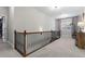 Upstairs hallway showcasing neutral carpet, ornate wood railing, and bright natural light from the window at 2061 Westwood Cir, Smyrna, GA 30080