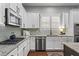 Contemporary kitchen featuring granite counters, stainless appliances, modern backsplash, and white cabinetry at 2061 Westwood Cir, Smyrna, GA 30080