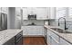 Close-up view of kitchen area showcasing granite counters, stainless appliances, and access to dining area at 2061 Westwood Cir, Smyrna, GA 30080