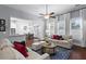 Bright living room with large windows, hardwood floors, neutral decor, and open to the dining area and kitchen at 2061 Westwood Cir, Smyrna, GA 30080