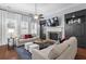 Comfortable living room featuring built-in shelving, a stone fireplace, and ample seating at 2061 Westwood Cir, Smyrna, GA 30080