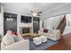 Cozy living room with a stone fireplace, built-in shelving, and a staircase leading upstairs at 2061 Westwood Cir, Smyrna, GA 30080