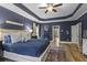 Bright main bedroom showcasing a king bed, hardwood floors, trey ceilings and neutral decor at 2061 Westwood Cir, Smyrna, GA 30080