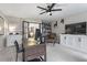 Spacious home office with a ceiling fan, black framed sliding doors and built-in shelving and cabinet at 2061 Westwood Cir, Smyrna, GA 30080