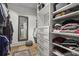 Organized walk-in closet featuring custom shelving, a dressing mirror, and hardwood floors at 2061 Westwood Cir, Smyrna, GA 30080