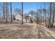 A lush backyard featuring a two-story house with a screened in porch and natural surroundings at 210 Joe Green Ln, Canton, GA 30114