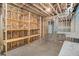 Unfinished basement area featuring wooden shelving and possible workshop area at 210 Joe Green Ln, Canton, GA 30114