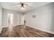 Large bedroom with wood flooring, neutral walls, a ceiling fan, and doors leading to other rooms at 210 Joe Green Ln, Canton, GA 30114