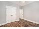 Bedroom features wood-look floors, double door closet, and a neutral color scheme at 210 Joe Green Ln, Canton, GA 30114