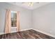 Bedroom featuring wood look floors, neutral walls, a window, and view of the outdoors at 210 Joe Green Ln, Canton, GA 30114