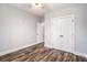 Neutral bedroom featuring modern ceiling fan, wood-look floors, and a double door closet at 210 Joe Green Ln, Canton, GA 30114