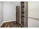 Walk-in closet featuring custom wood shelving and wood flooring for organized storage at 210 Joe Green Ln, Canton, GA 30114