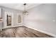 Cozy dining area featuring wood floors, modern light fixture, and a view to the back porch at 210 Joe Green Ln, Canton, GA 30114