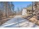 Long driveway leading up to a charming home featuring an elevated front porch and two-car garage at 210 Joe Green Ln, Canton, GA 30114