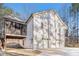 A rear exterior view of a two-story home, featuring a three-car garage and screened porch at 210 Joe Green Ln, Canton, GA 30114