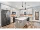 Modern kitchen features white cabinets, stainless steel appliances, brick backsplash and an island at 210 Joe Green Ln, Canton, GA 30114