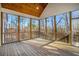 Enclosed porch boasting panoramic views, tongue and groove ceiling, and seamless outdoor connection at 210 Joe Green Ln, Canton, GA 30114