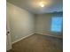 Bedroom with neutral carpeting, one window bringing in natural light, and a simple, clean design at 3851 Guilderoy Ln # 1, Austell, GA 30106