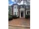 Inviting brick townhome with well-maintained landscaping and classic architectural details at 3851 Guilderoy Ln # 1, Austell, GA 30106