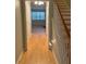 Hallway with wood floors leading to the stairwell at 3851 Guilderoy Ln # 1, Austell, GA 30106