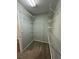 Organized walk-in closet with carpeted floors and multiple levels of shelving for optimal storage solutions at 3851 Guilderoy Ln # 1, Austell, GA 30106