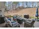 Inviting back deck with comfortable seating around a fire pit, ideal for relaxing outdoors in a serene setting at 4000 Rockingham Dr, Roswell, GA 30075