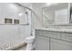 Updated bathroom with stylish vanity, granite counters, framed mirrors, and a glass enclosed tiled shower at 4000 Rockingham Dr, Roswell, GA 30075