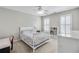 Bedroom with white furniture including a floral print bed, a desk, and white shuttered windows at 4000 Rockingham Dr, Roswell, GA 30075