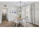 Cozy dining area with a round table, modern lighting, and a view into an adjacent bathroom at 4000 Rockingham Dr, Roswell, GA 30075