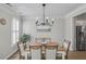 Open dining area featuring a modern chandelier, hardwood floors, and ample natural light, great for gatherings at 4000 Rockingham Dr, Roswell, GA 30075