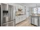 Spacious kitchen featuring stainless steel refrigerator, granite countertops, modern cabinetry and a breakfast bar at 4000 Rockingham Dr, Roswell, GA 30075